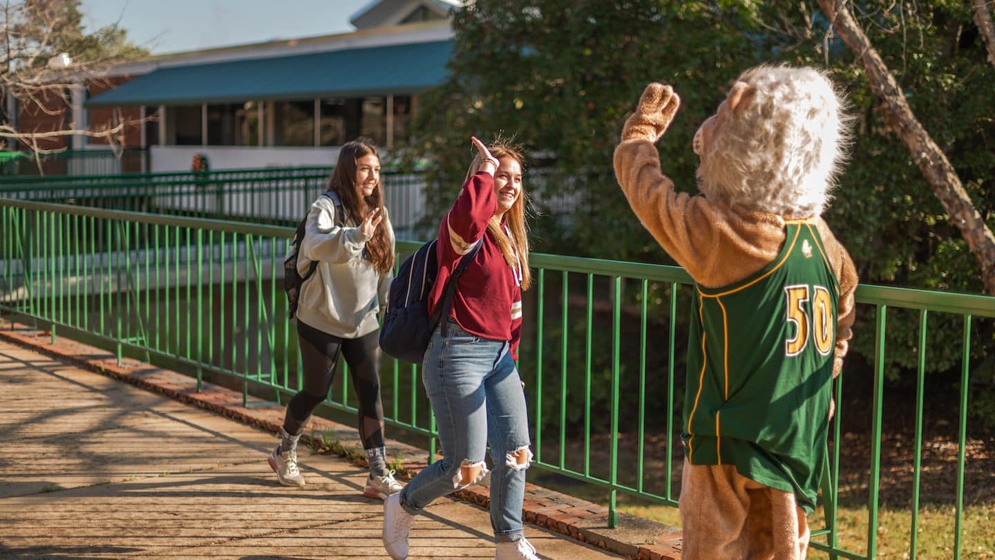 Methodist University mascot high fives students