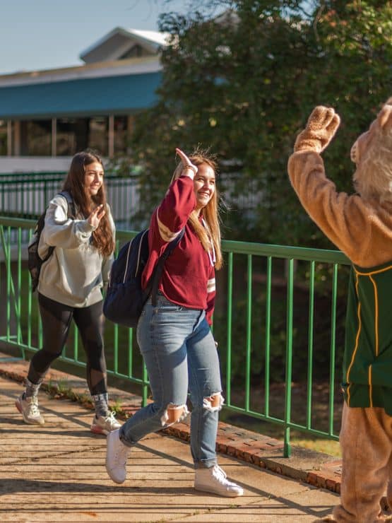 Methodist University mascot high fives students