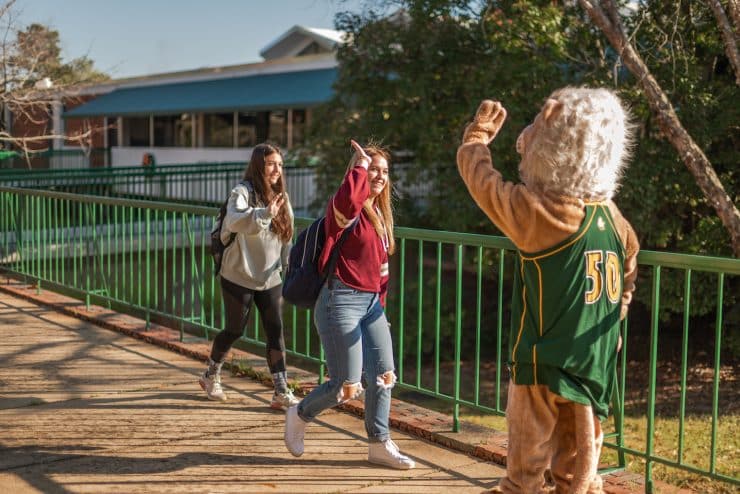 Methodist University mascot high fives students