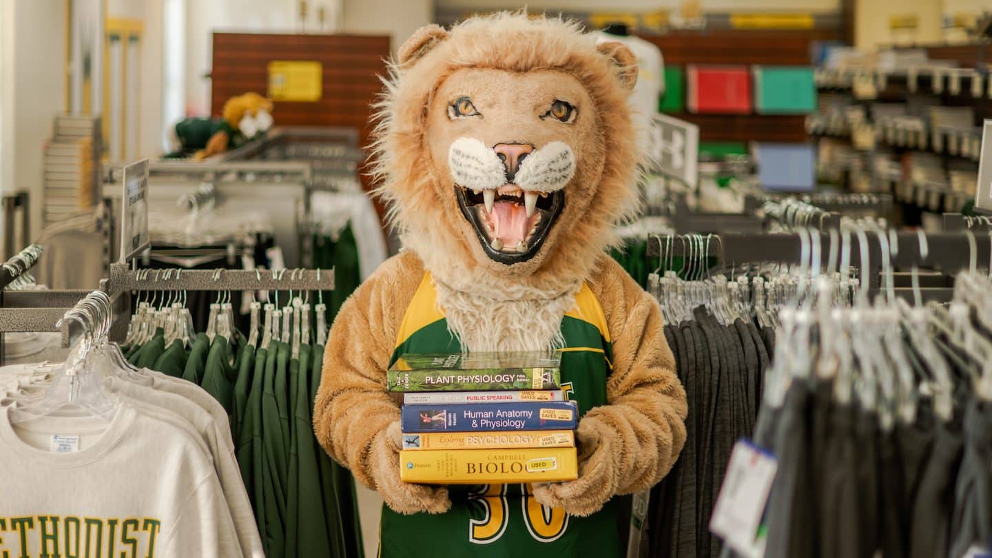 Methodist University mascot King holds his new books for class