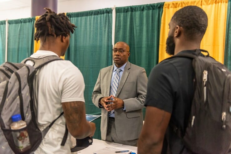 Students meet with an employer at a career fair