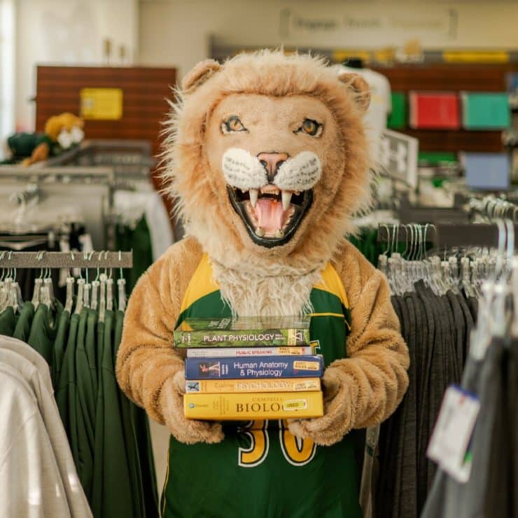 Methodist University Mascot King stocks up on used textbooks at the Bookstore!