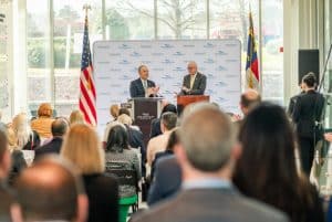 Michael Nagowski, CEO of Cape Fear Valley Health, and Methodist University President Stanley T. Wearden speak to a full room