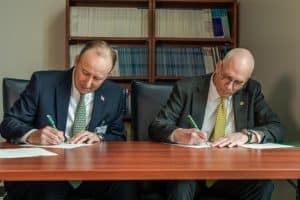 Michael Nagowski and Dr. Stanley T. Wearden sign an agreement between Cape Fear Valley Health and Methodist University