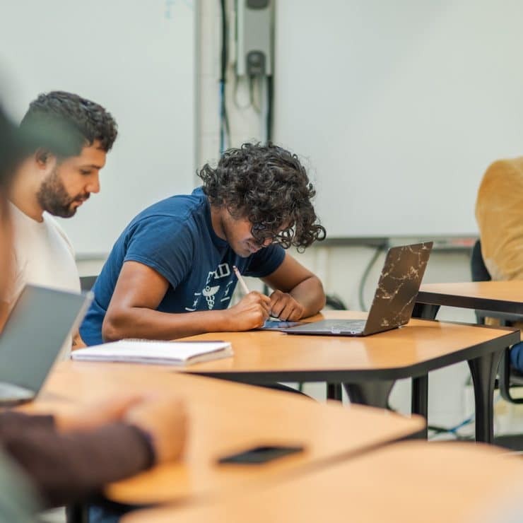 Student writes in an English class at Methodist University