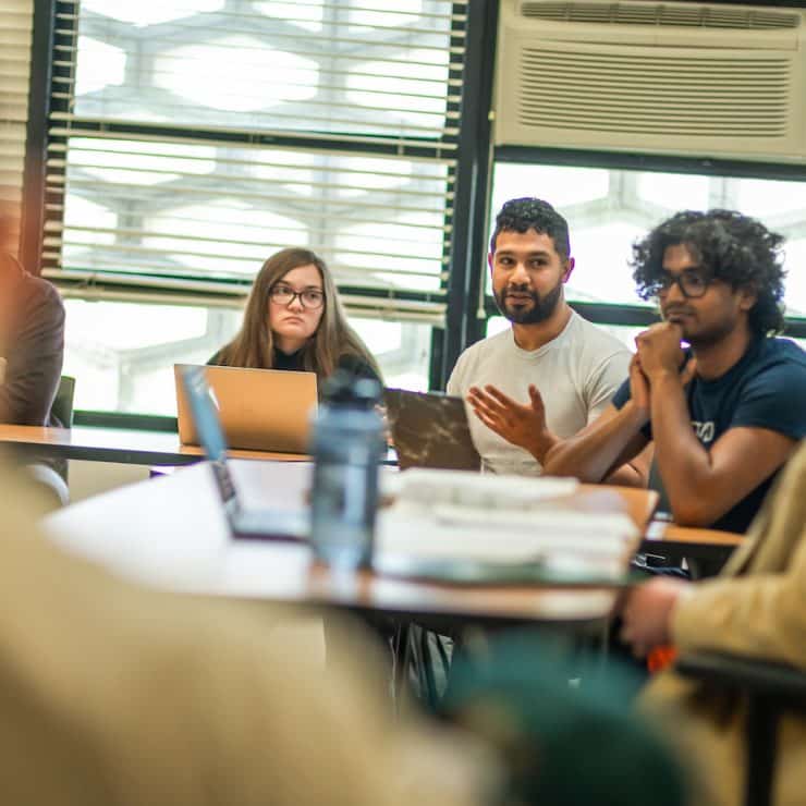 Students discuss a topic during an English class