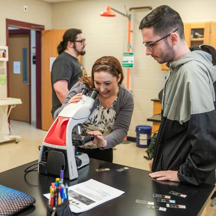 Methodist University professor reviews a Biology student's work.