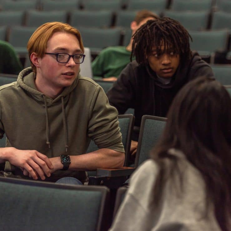 Methodist University Business Administration students discuss a topic in class.