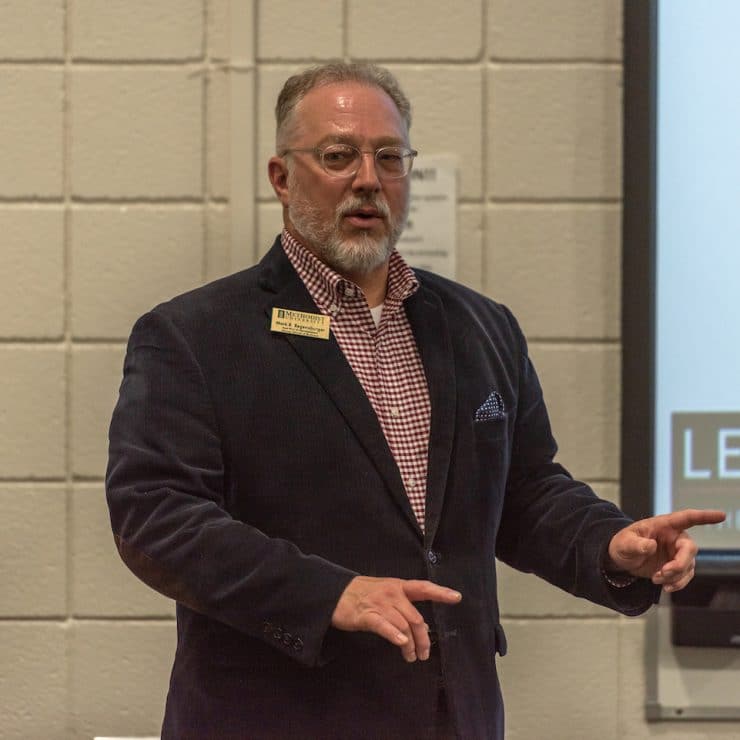 Methodist University professor Mark Regensburger instructs his Business Administration class.