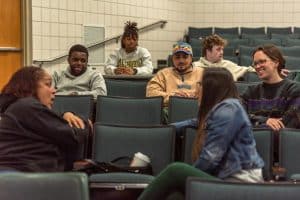 A small group of students discuss in a Business Administration class.
