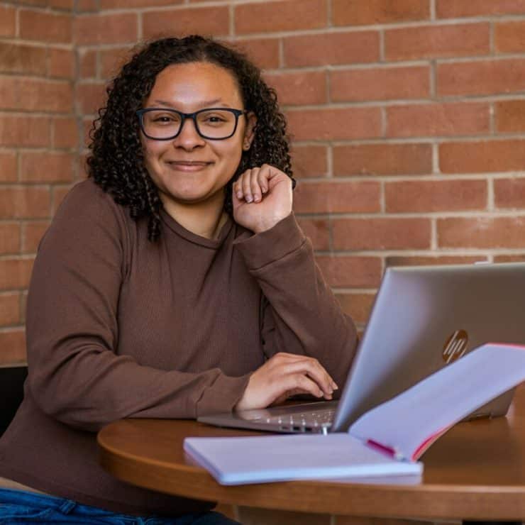 A student works on her laptop in the Davis Memorial Library