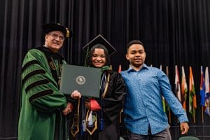 Lauryn Fisher receives her diploma from Dr. Stanley T. Wearden