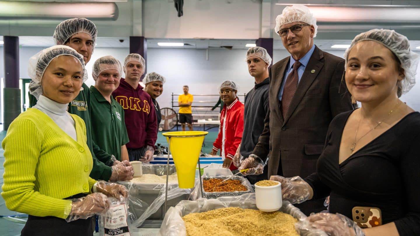 Students and President Wearden pack meals for Rise Against Hunger