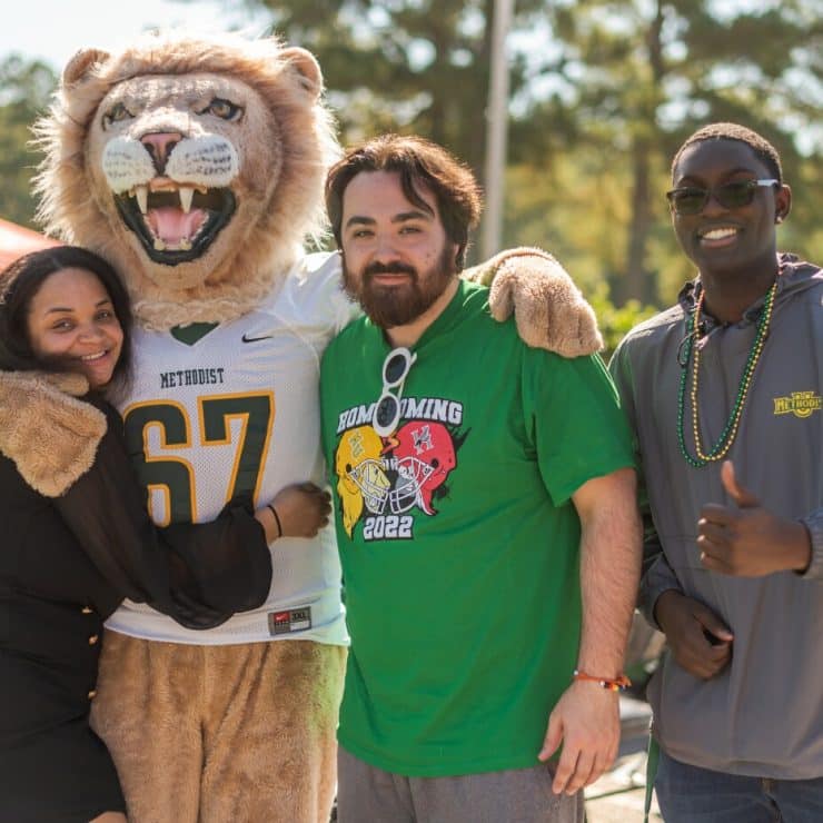 Mascot King poses with students at Homecoming
