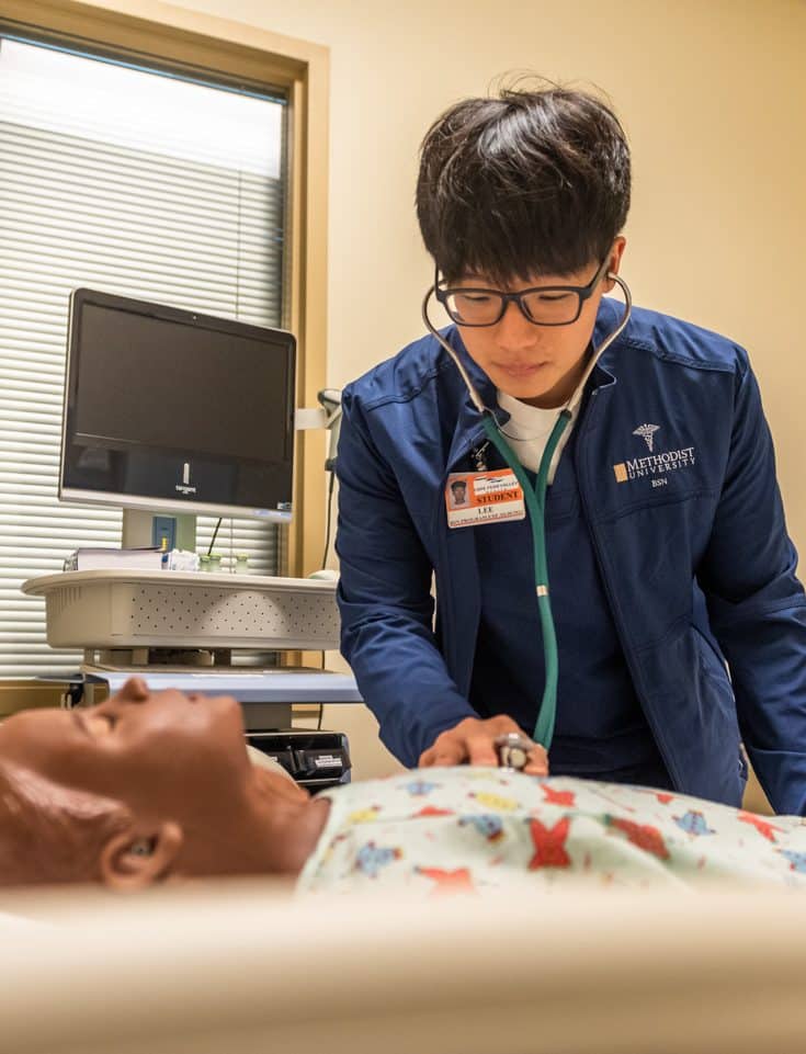 An MU Student Nurse works with a manakin in the General Simulation Hospital