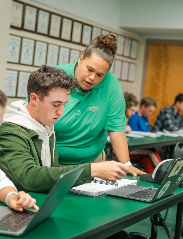 Professional Golf Management professor Kelsie Warren works with students