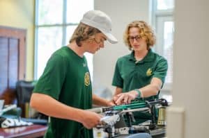 PTM Students work with racquet repair