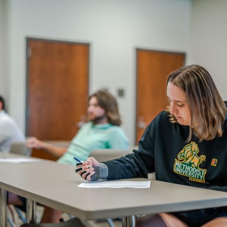 Methodist University PTM students takes notes in class.