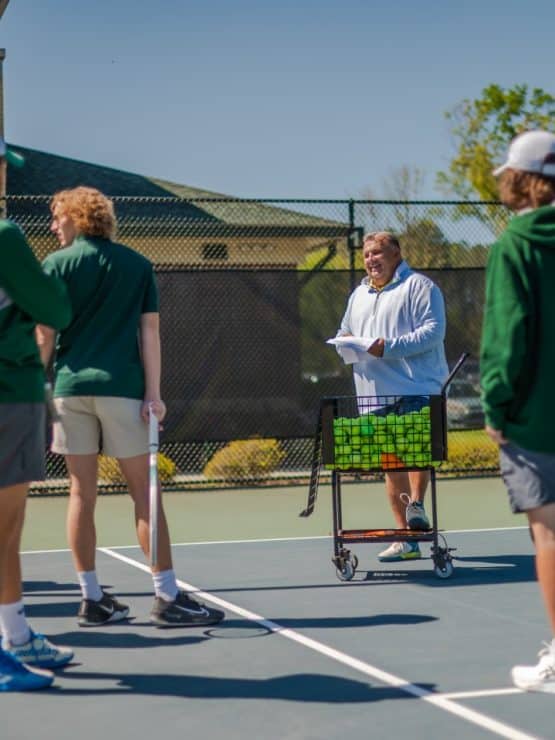 Methodist University PTM students take instruction on the tennis court.