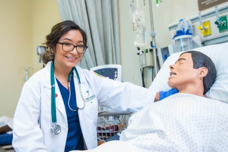 A student works with a manakin in the General Simulation Hospital of the Robert J. Chaffin Nursing Building