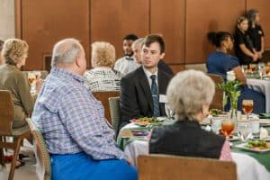 A student sits with scholarship donors