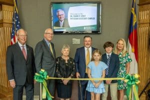 Trustee Tim Richardson, President Stanley T. Wearden, and the Stout family