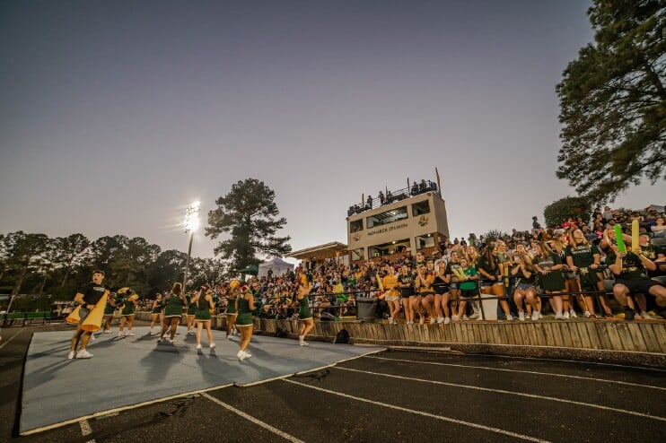 Homecoming Football game crowd at Monarch Stadium with cheerleaders