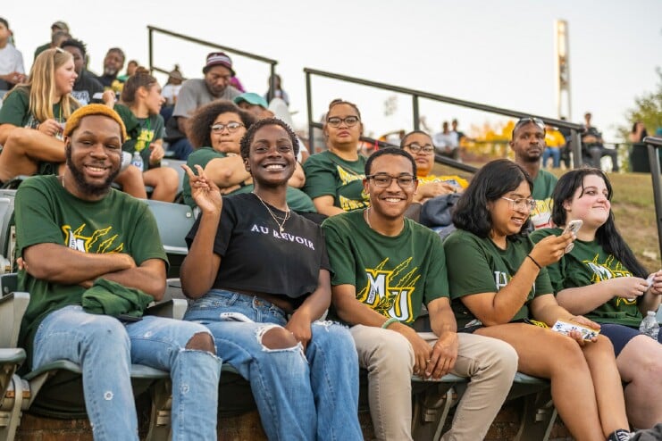 Students in the crowd at the Homecoming football game