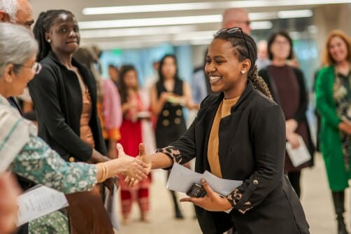 An international student receives congratulations