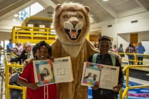 Methodist University Mascot King with children