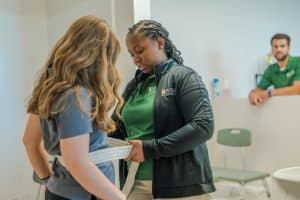 An occupational therapy student works with a client