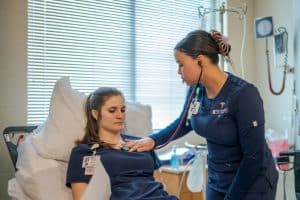 Student nurses work together in the simulation hospital