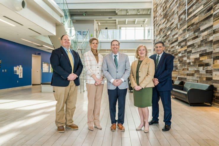 The Methodist University Cape Fear Valley Health School of Medicine leadership team stands in Methodist University's McLean Health Sciences Building (left to right): Scott Bullard (Chief of Staff), Dr. Stephanie Mann (Senior Associate Dean for Academic Affairs), Dr. Hershey Bell (Founding Dean), Dr. Kimberly Vess (Senior Associate Dean for Student Experience), and John Worth (Senior Associate Dean for Administration and Finance).