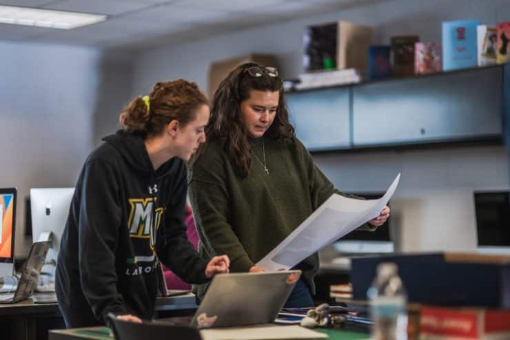 Graphic Design Professor Tori Hord consults with a student