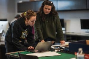 Graphic Design Professor Tori Hord consults with a student