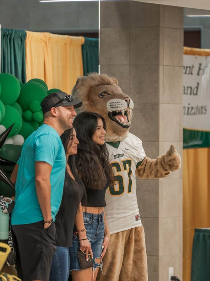 A student poses with her family