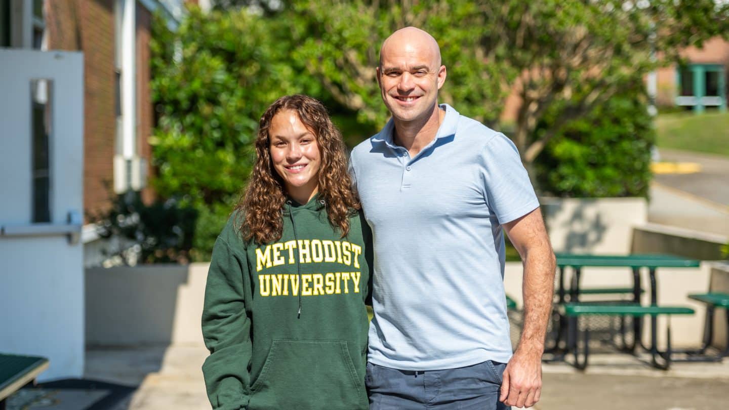 A student poses with a parent or guardian
