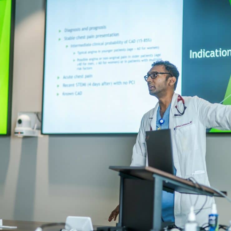 A professor delivers a lecture to medical students