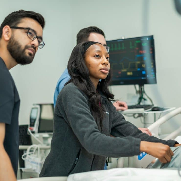 Medical students work with a manakin