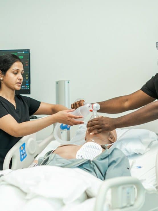 Medical students work with a manakin