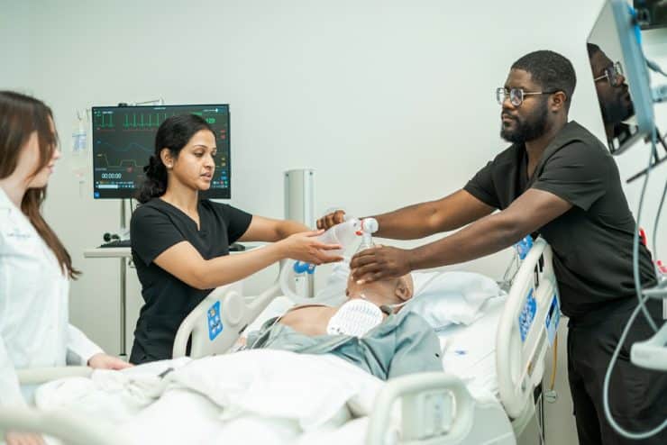 Medical students work with a manakin