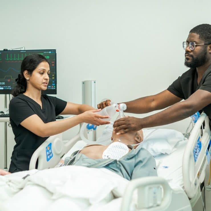 Medical students work with a manakin