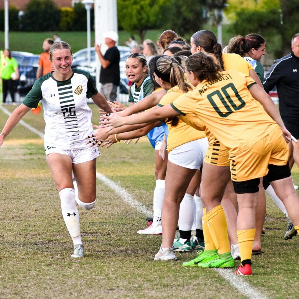 Women's Soccer players congratulate each other