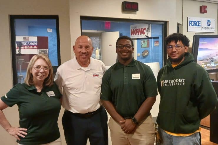 Members of the Methodist University Student Marketing Agency appear with radio host Gilbert Baez
