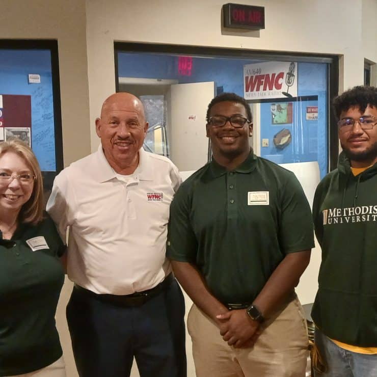 Members of the Methodist University Student Marketing Agency appear with radio host Gilbert Baez