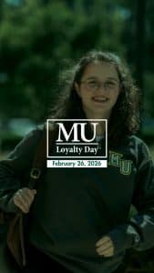 A student walking on campus with the Methodist University Loyalty Day logo