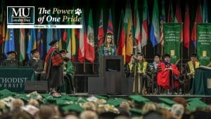A student at graduation with the Methodist University Loyalty Day logo