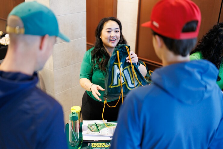 Jenny Xiong greets students at the open house