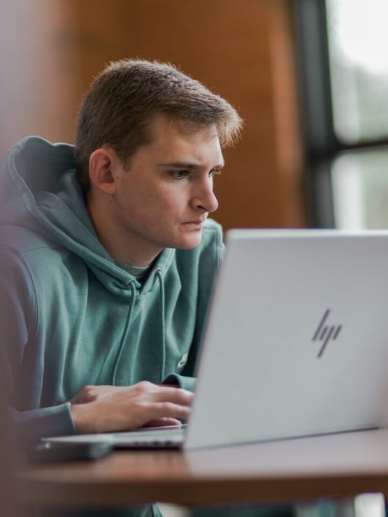 A student works on a laptop in Davis Memorial Library
