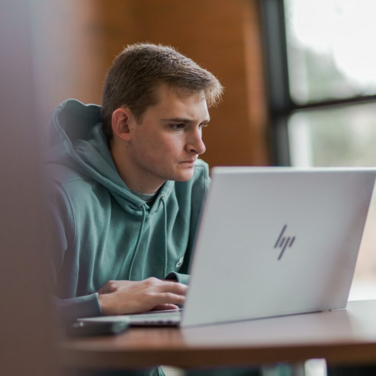 A student works on a laptop in Davis Memorial Library